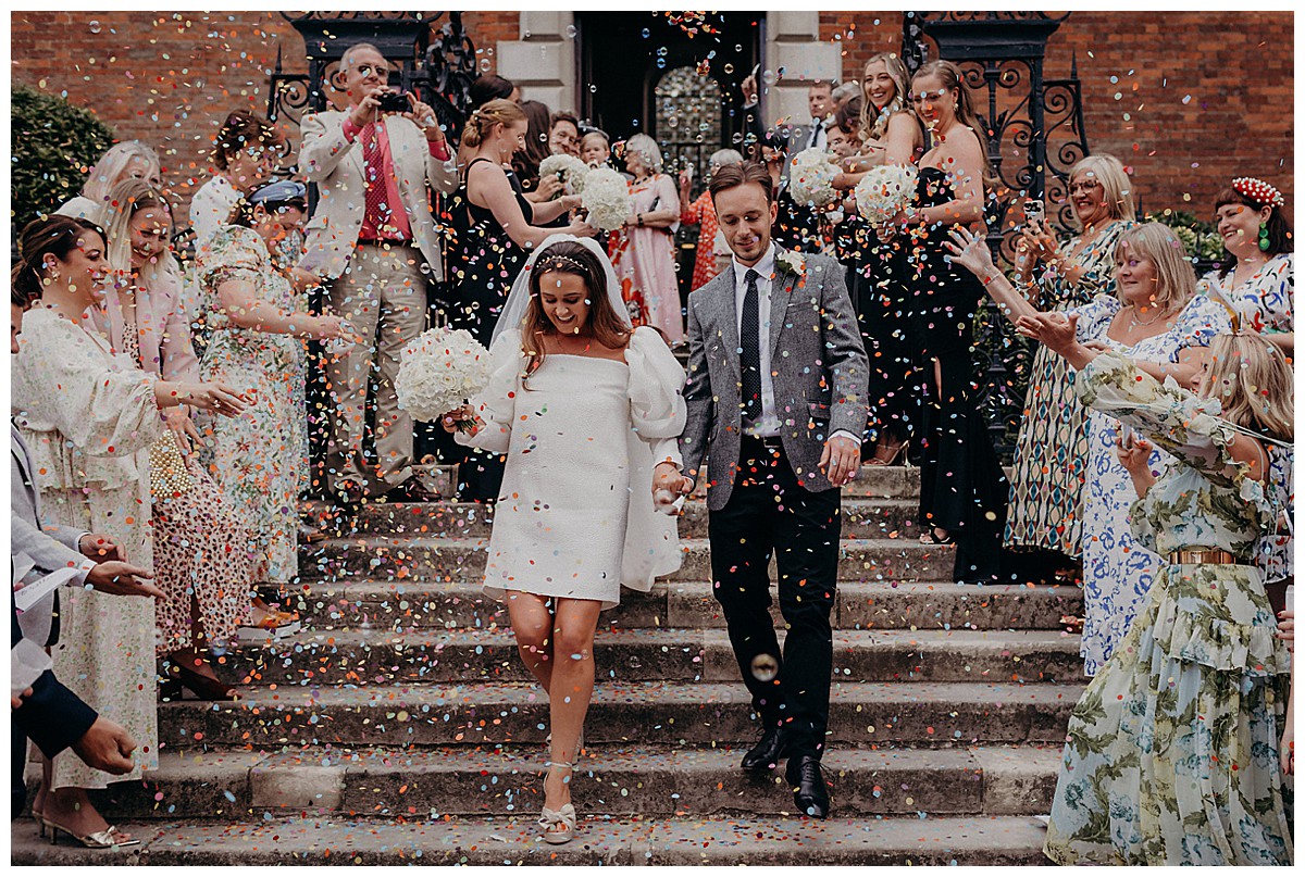 newly wed couple outside holy trinity church in Guildford in surrey