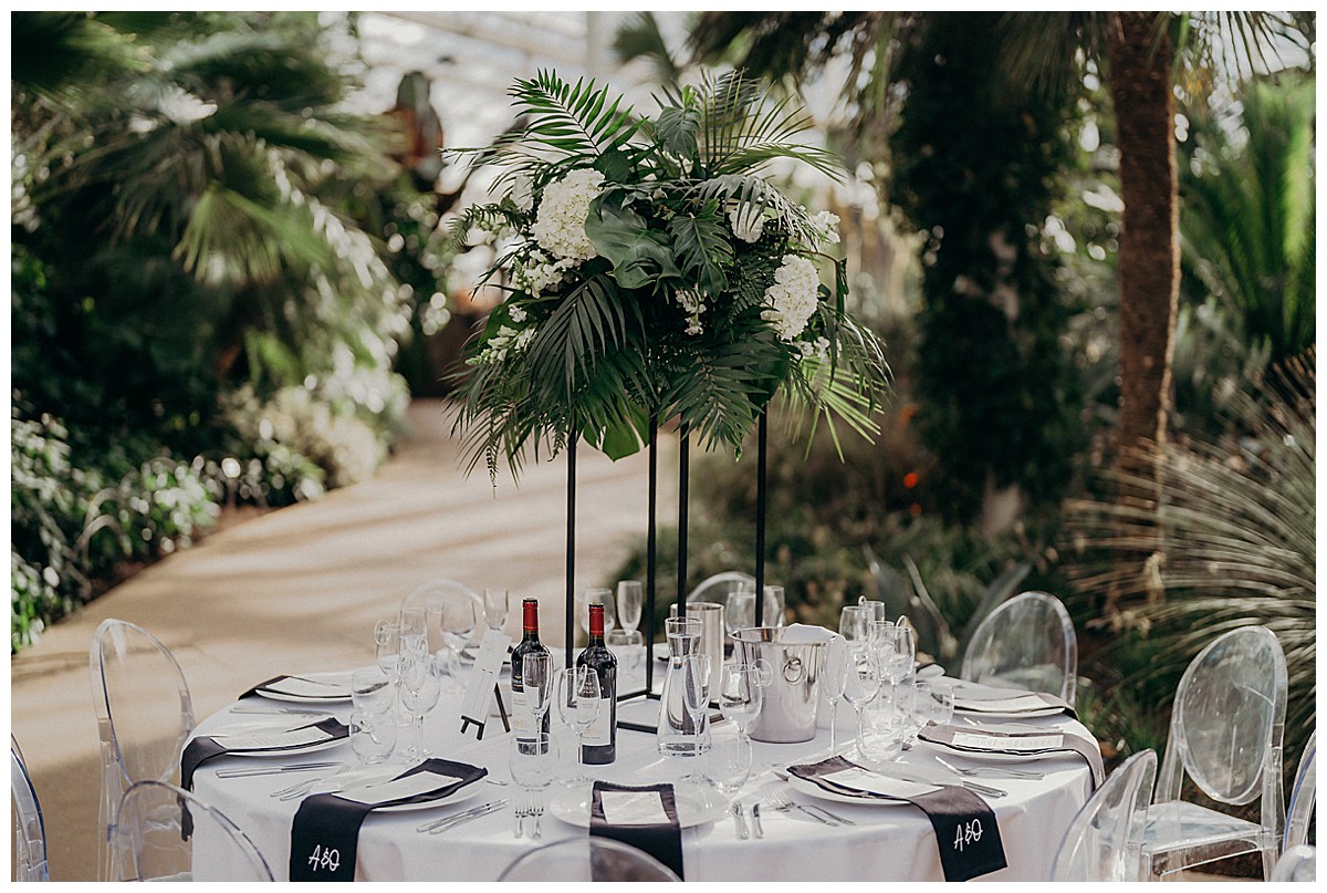botanical black & white wedding centrepiece with black tall geometric stands at RHS Wisley wedding