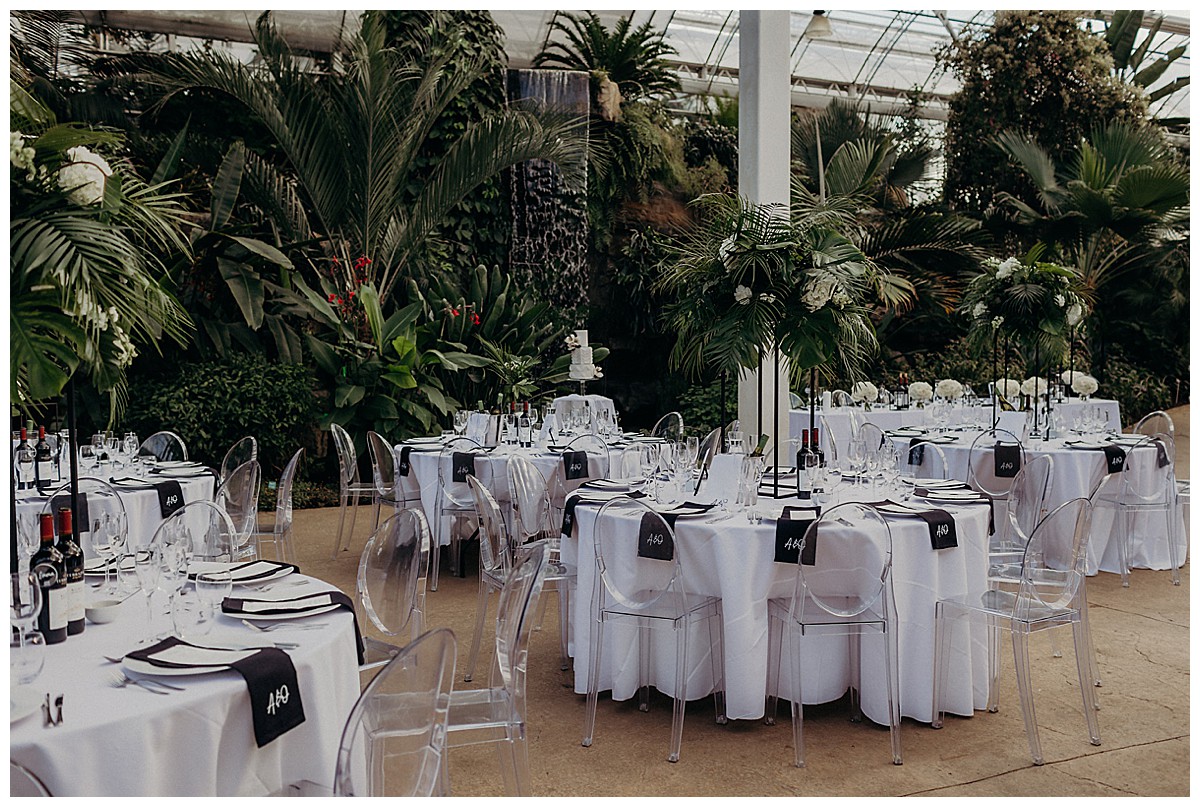 modern black & white wedding with ghost chairs, at RHS Wisley Gardens glasshouse